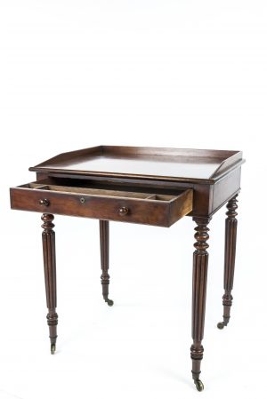 A REGENCY MAHOGANY WRITING TABLE ATTRIBUTED TO GILLOWS