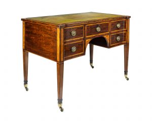 A 19th Century Figured Mahogany Writing Desk With Tooled Leather Inset Top by Wright and Mansfield