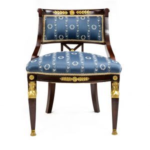 A French Empire style chair in mahogany with omalu mounts and masks